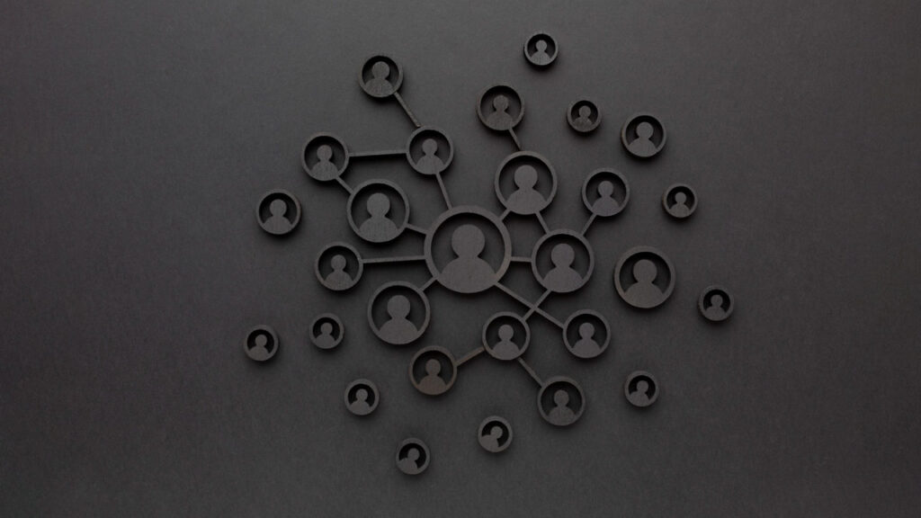 Silhouettes of connected user icons on a dark background, depicting a network or social connections concept.